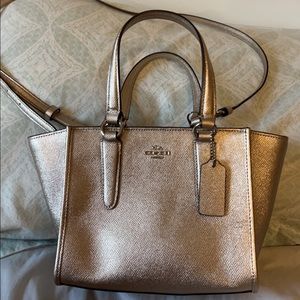 Gold Coach cross body bag gold color good condition a very minor scratch clean